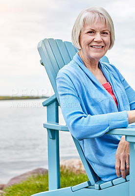 Buy stock photo Portrait of a happy senior woman relaxing on a chair outside