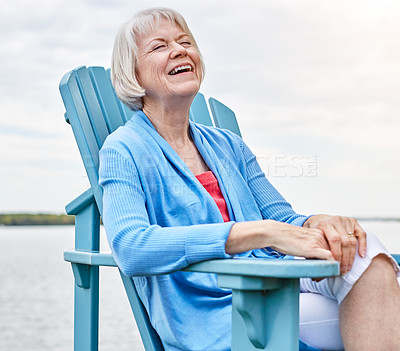 Buy stock photo Shot of a happy senior woman relaxing on a chair outside