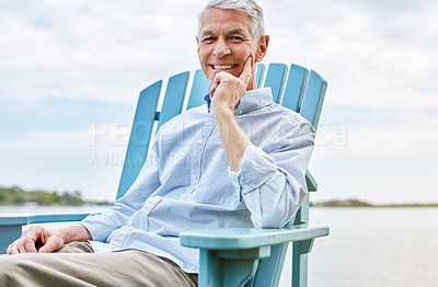 Buy stock photo Portrait of a happy senior man relaxing on a chair outside