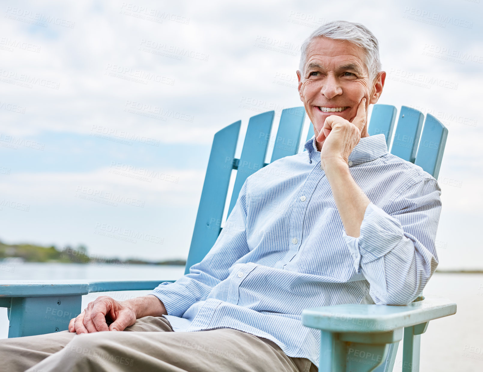 Buy stock photo Shot of a happy senior man relaxing on a chair outside