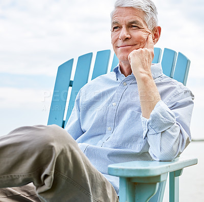 Buy stock photo Shot of a thoughtful senior man relaxing on a chair outside