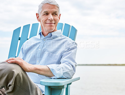 Buy stock photo Shot of a thoughtful senior man relaxing on a chair outside