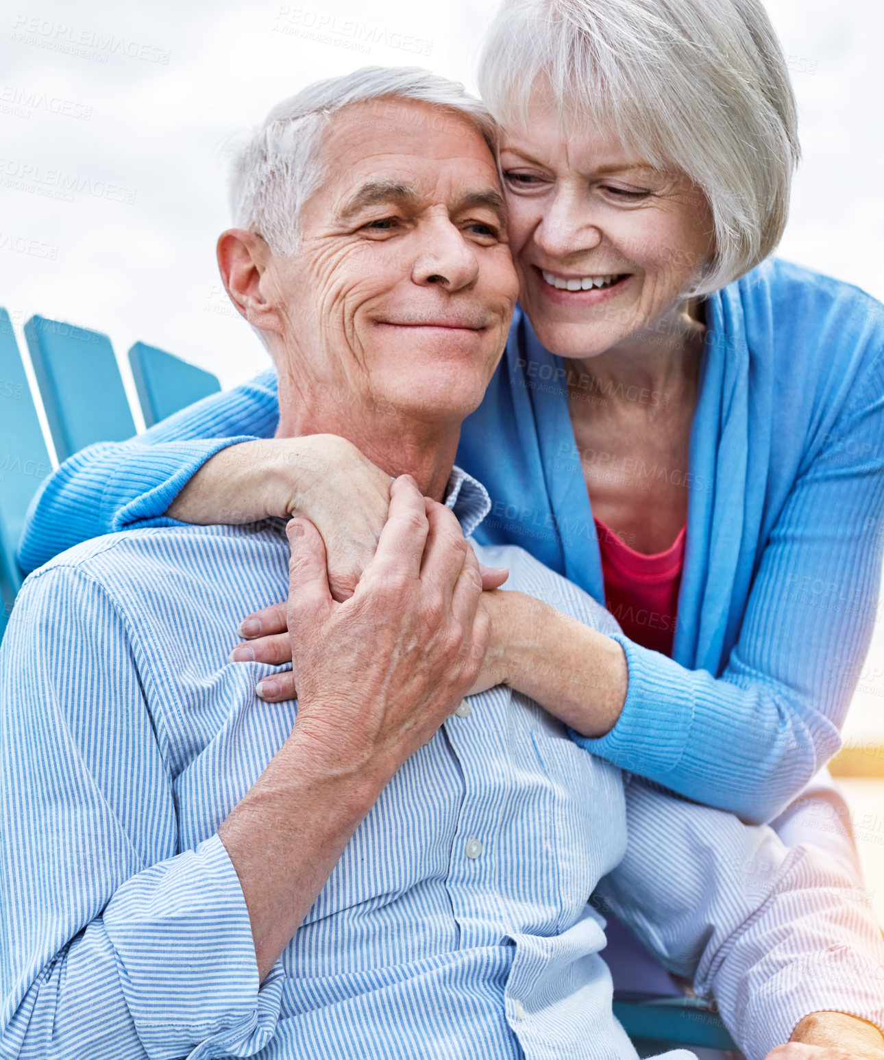 Buy stock photo Shot of an affectionate senior couple relaxing on chairs together outside