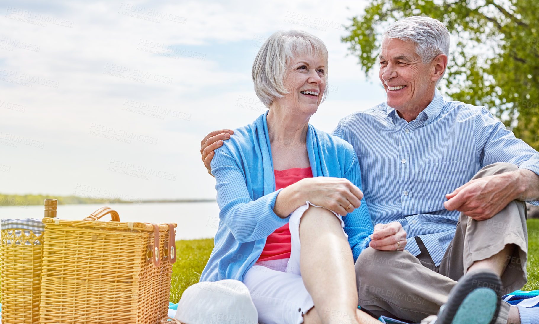 Buy stock photo Shot of a happy senior couple having a picnic together outside