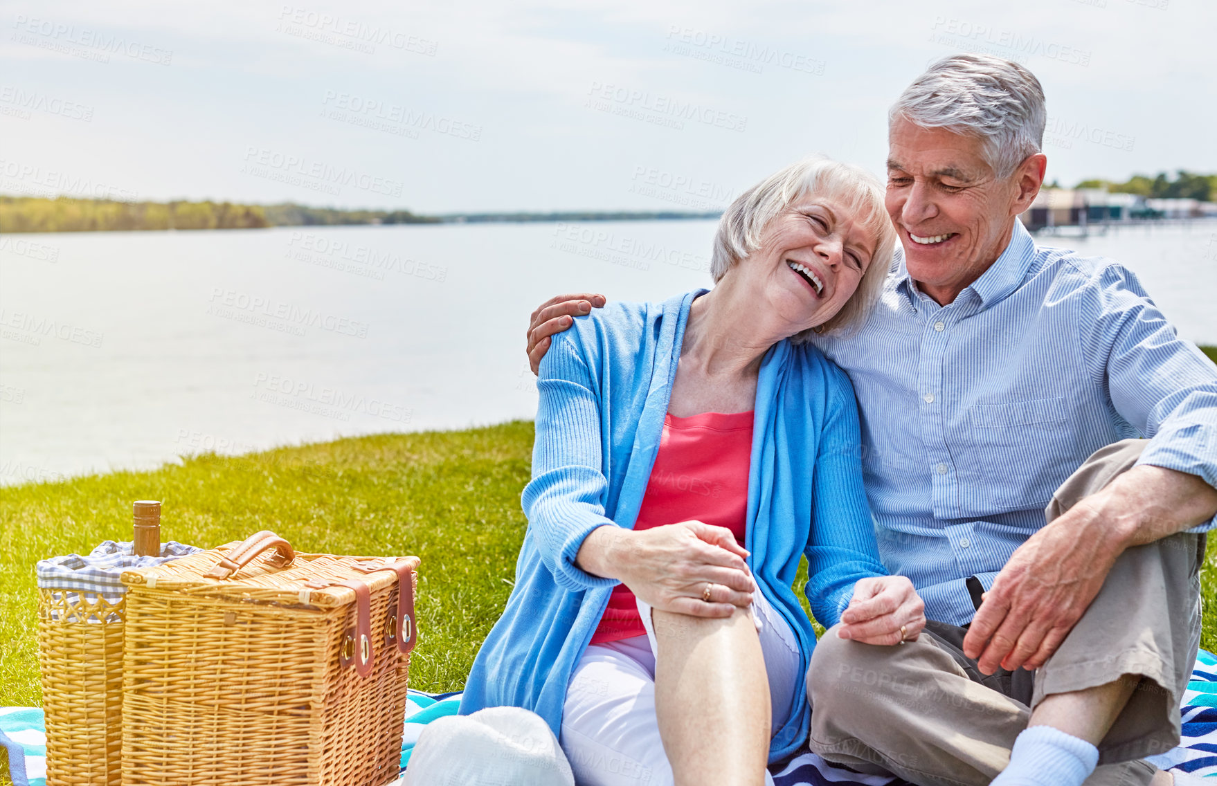 Buy stock photo Shot of a happy senior couple having a picnic together outside