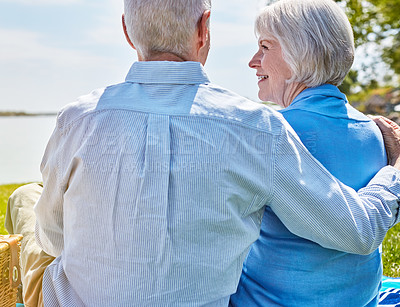 Buy stock photo Shot of a happy senior couple having a picnic together outside