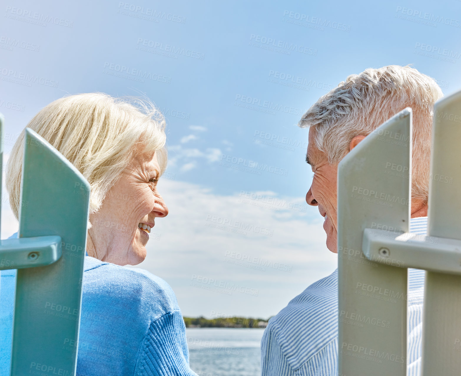 Buy stock photo Shot of an affectionate senior couple relaxing on chairs together outside