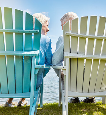 Buy stock photo Shot of an affectionate senior couple relaxing on chairs together outside