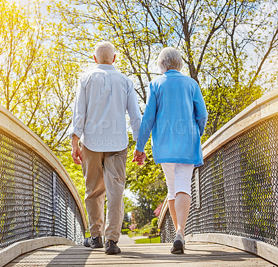 Buy stock photo Rearview shot of a senior couple going for a relaxing walk together outside