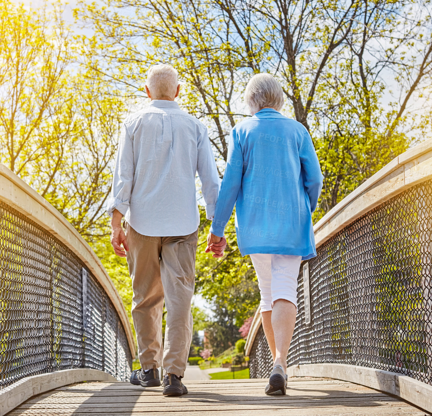 Buy stock photo Rearview shot of a senior couple going for a relaxing walk together outside