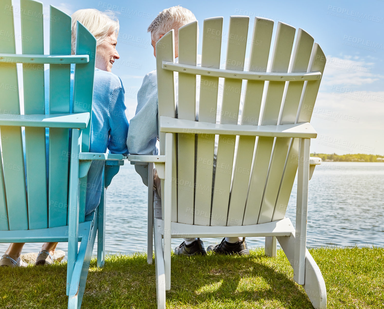 Buy stock photo Shot of an affectionate senior couple relaxing on chairs together outside