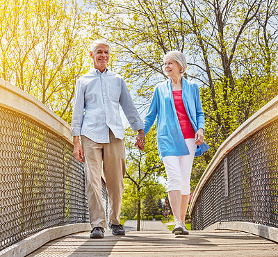 Buy stock photo Portrait of a happy senior couple going for a relaxing walk together outside