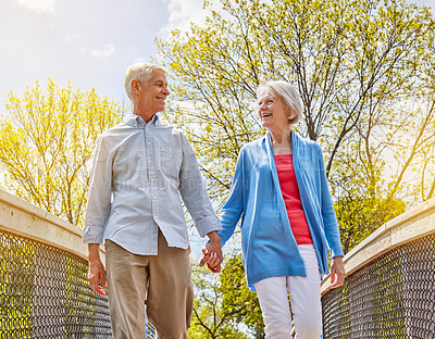 Buy stock photo Shot of a happy senior couple going for a relaxing walk together outside