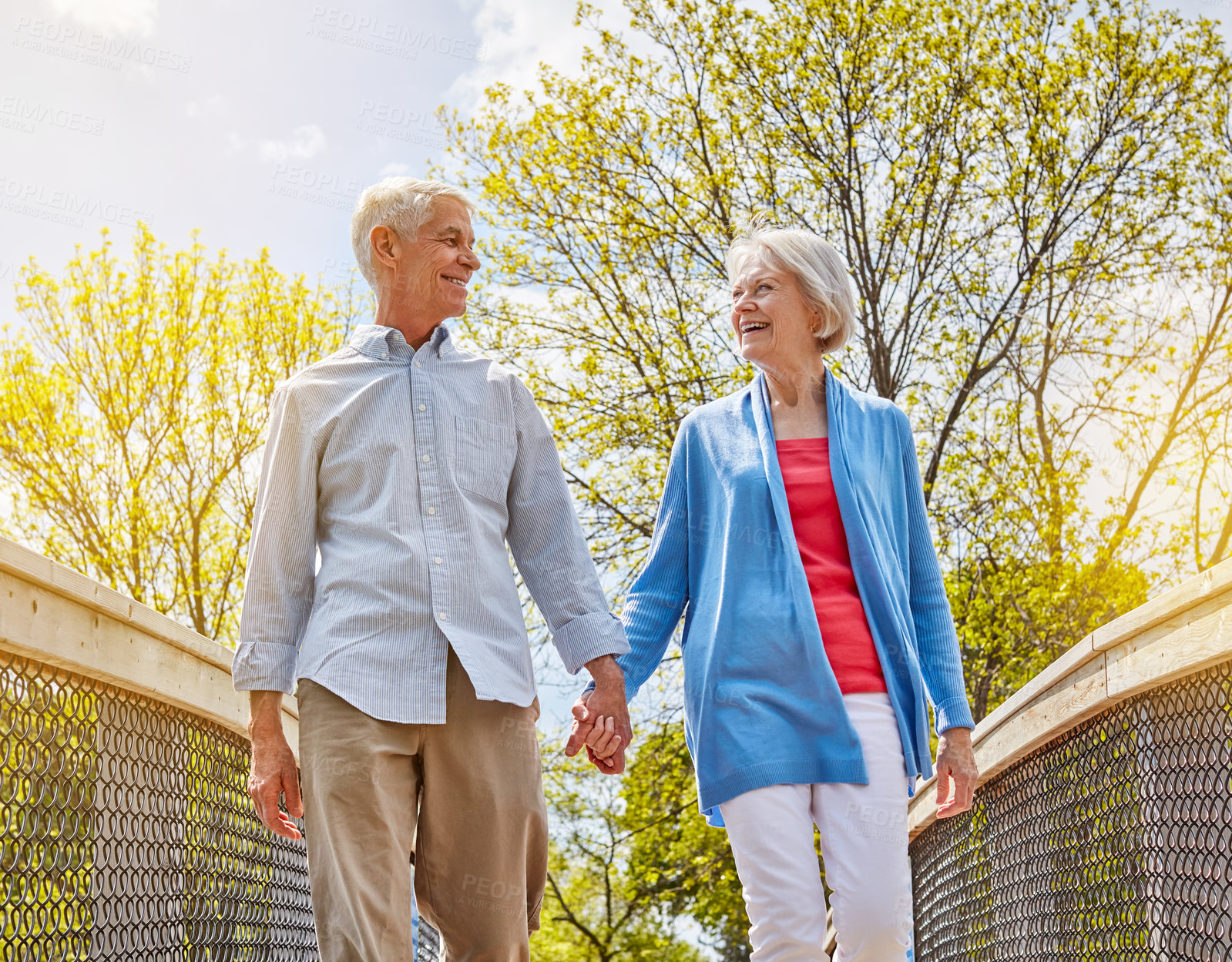 Buy stock photo Shot of a happy senior couple going for a relaxing walk together outside