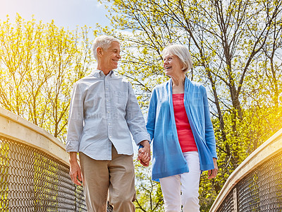 Buy stock photo Shot of a happy senior couple going for a relaxing walk together outside