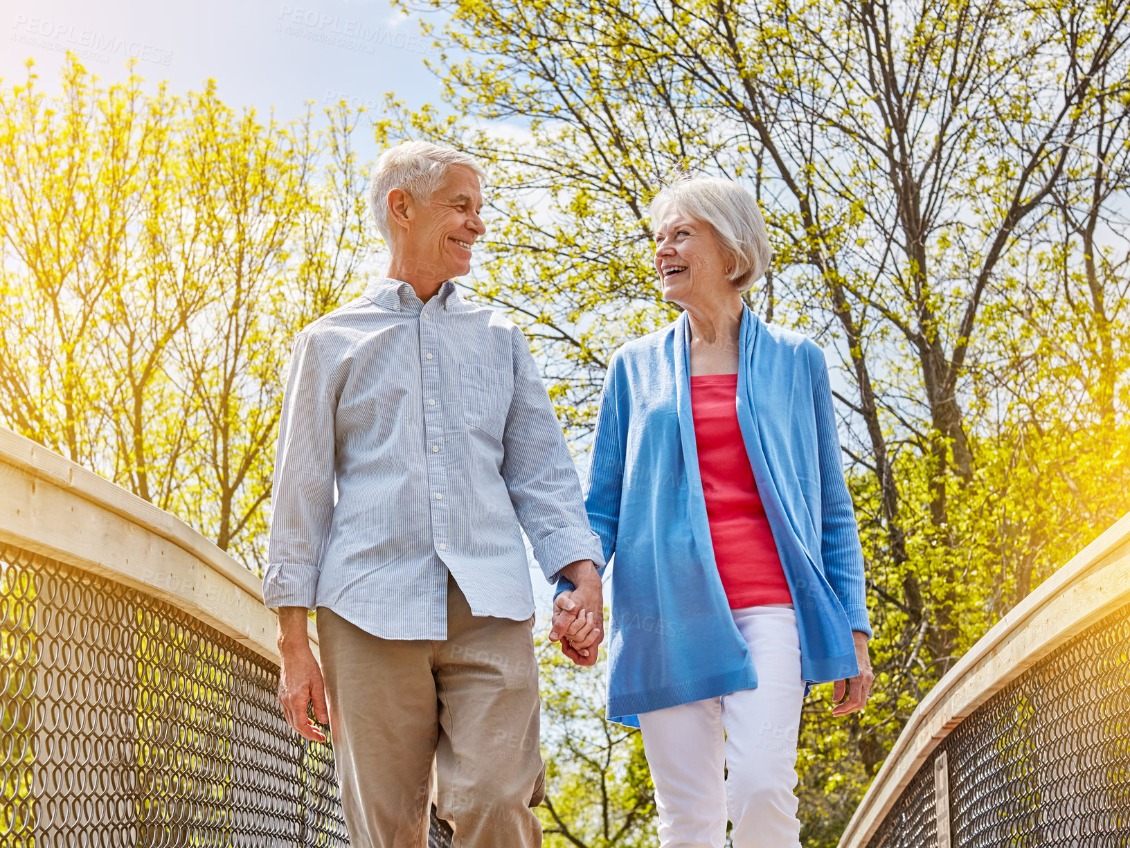 Buy stock photo Shot of a happy senior couple going for a relaxing walk together outside