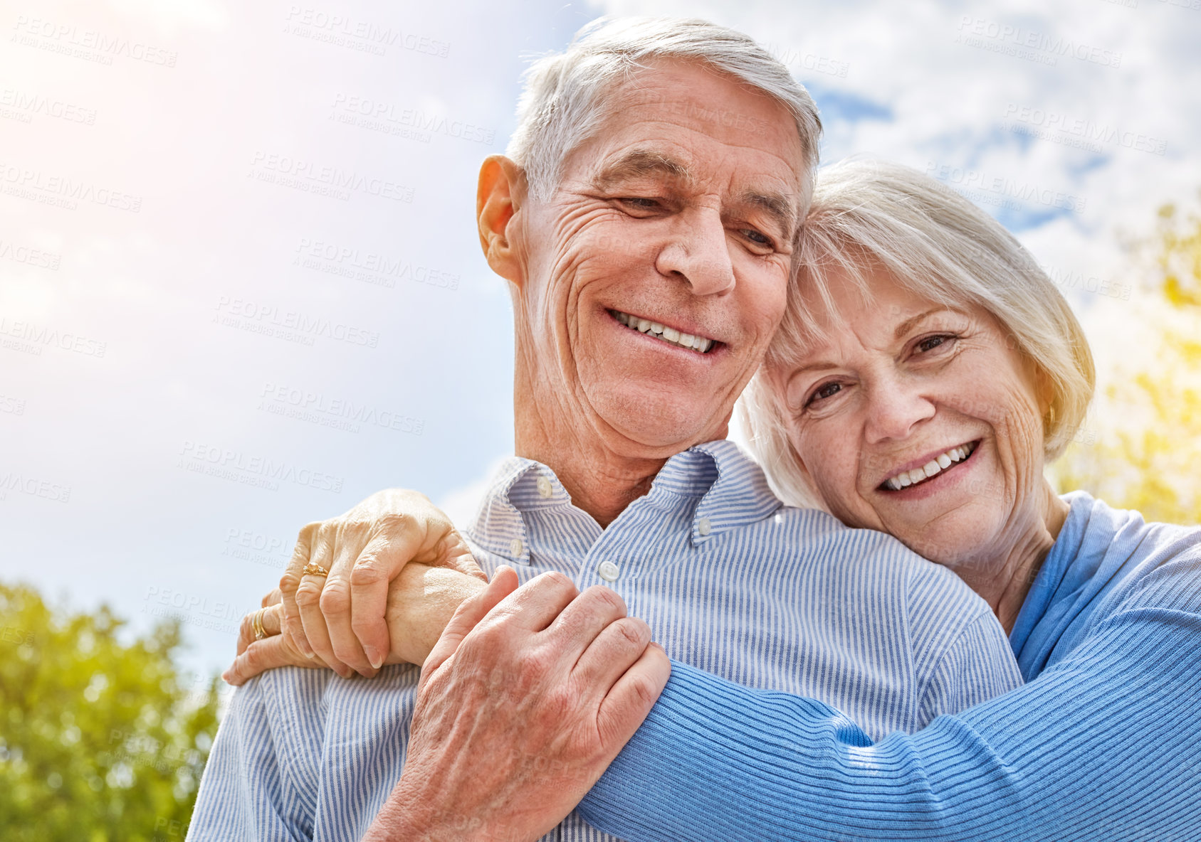 Buy stock photo Portrait of a happy senior couple in a loving embrace outside