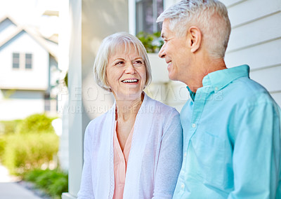 Buy stock photo Cropped shot of an affectionate senior couple sitting outside on their porch during the summer