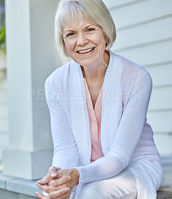 Buy stock photo Cropped portrait of a senior woman sitting on her porch during the summer