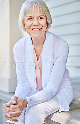 Buy stock photo Cropped portrait of a senior woman sitting on her porch during the summer