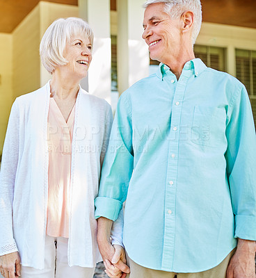 Buy stock photo Cropped shot of an affectionate senior couple standing outside on their porch during the summer