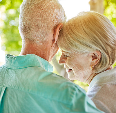 Buy stock photo Rearview shot of an affectionate senior couple standing outside during the summer