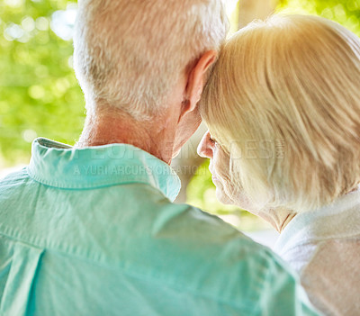 Buy stock photo Rearview shot of an affectionate senior couple standing outside during the summer