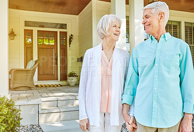 Buy stock photo Cropped shot of an affectionate senior couple standing outside on their porch during the summer