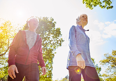 Buy stock photo Walk, life insurance and elderly couple in nature for retirement, security and love in park. Senior man, woman and together for support with low angle, happiness or fitness outdoors in Australia