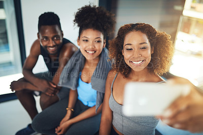 Buy stock photo Portrait shot of three young friends taking a selfie together inside of a studio