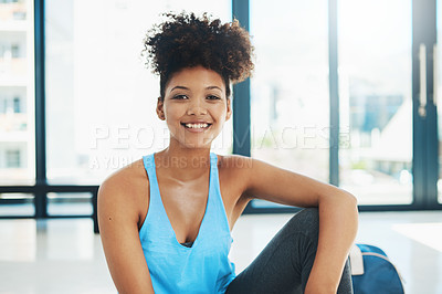 Buy stock photo Portrait shot of a young fit woman sitting down on the floor and taking a break after a workout session