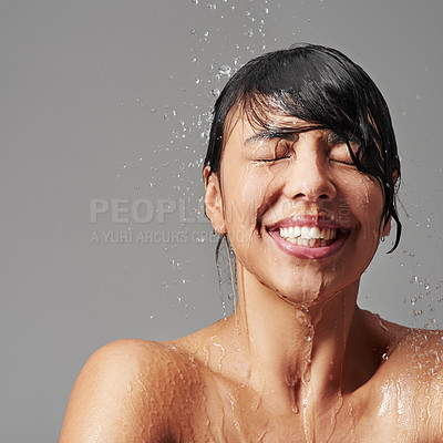 Buy stock photo Shower, cleaning and face of woman with water splash in studio for wellness, beauty and grooming. Skincare, bathroom and happy female person for washing hair, body and cleansing on grey background