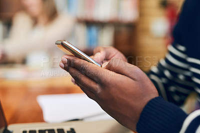 Buy stock photo Cropped shot of an unrecognizable student using his cellphone