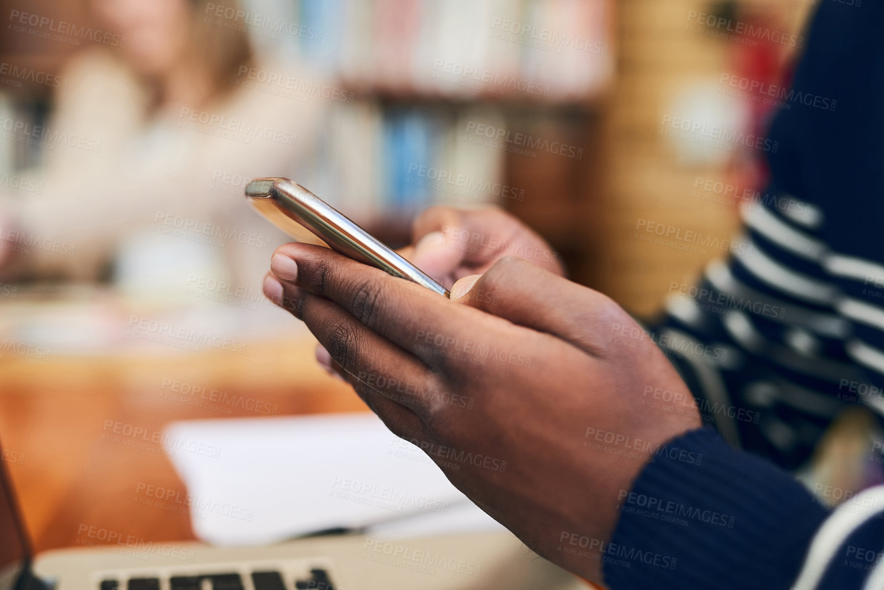 Buy stock photo Phone, library and hands of man with laptop at university for education, communication or online chat. Computer, smartphone and college student on mobile app for study schedule, research or project