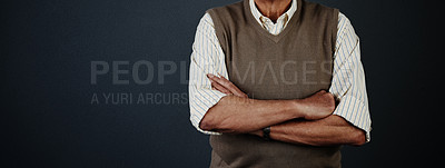 Buy stock photo Studio shot of an unrecognizable man posing with his arms crossed against a dark background