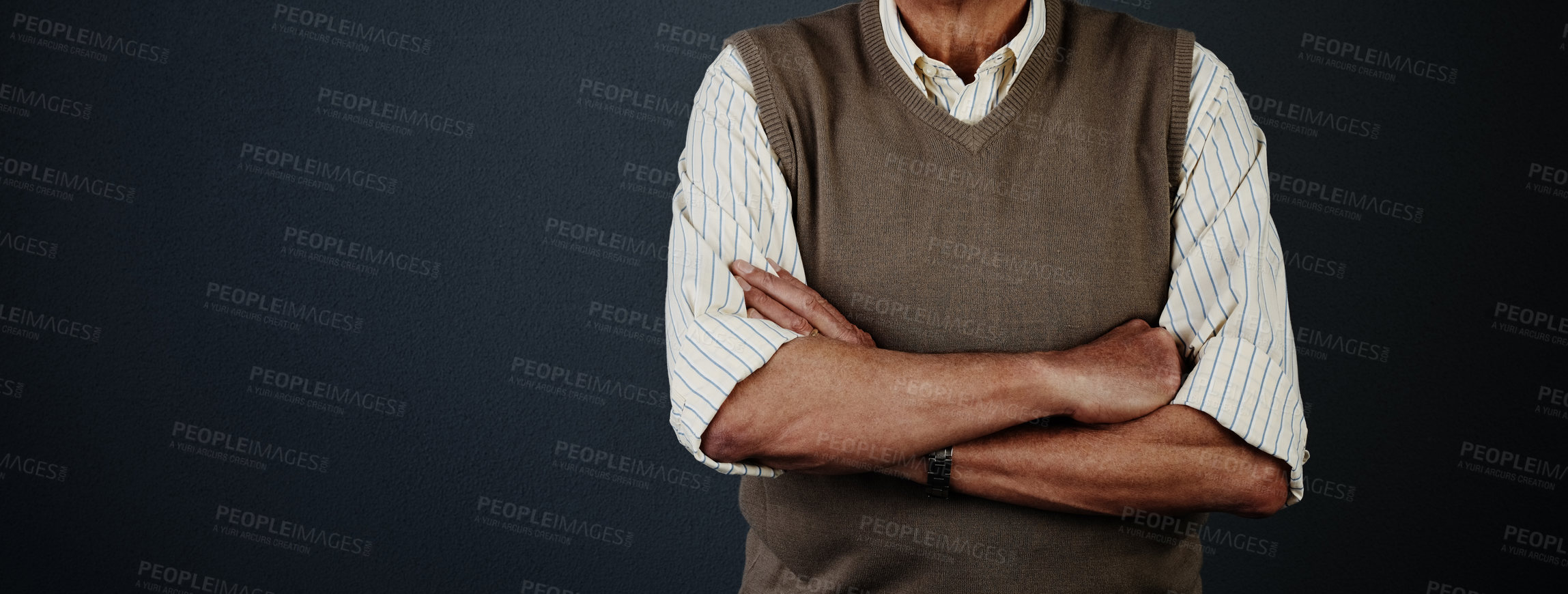Buy stock photo Studio shot of an unrecognizable man posing with his arms crossed against a dark background