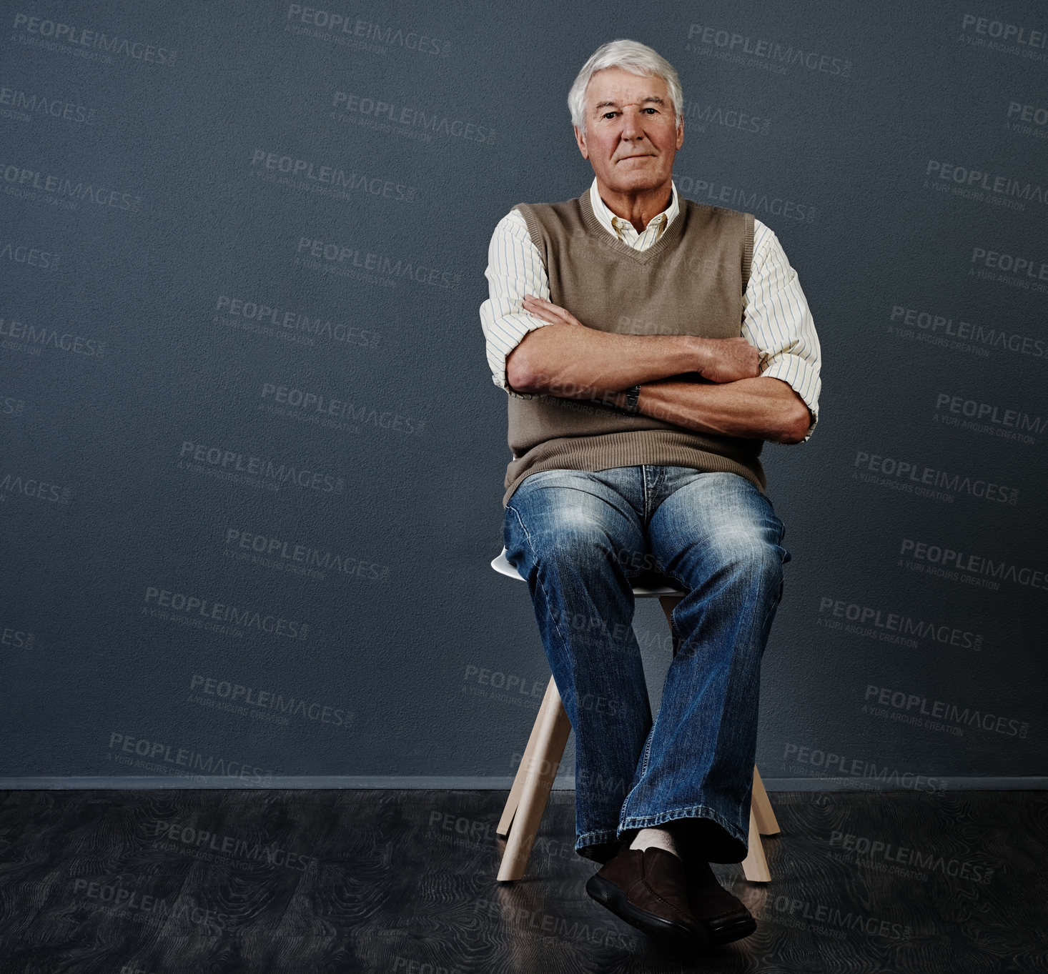 Buy stock photo Studio portrait of a handsome mature man posing with his arms crossed against a dark background
