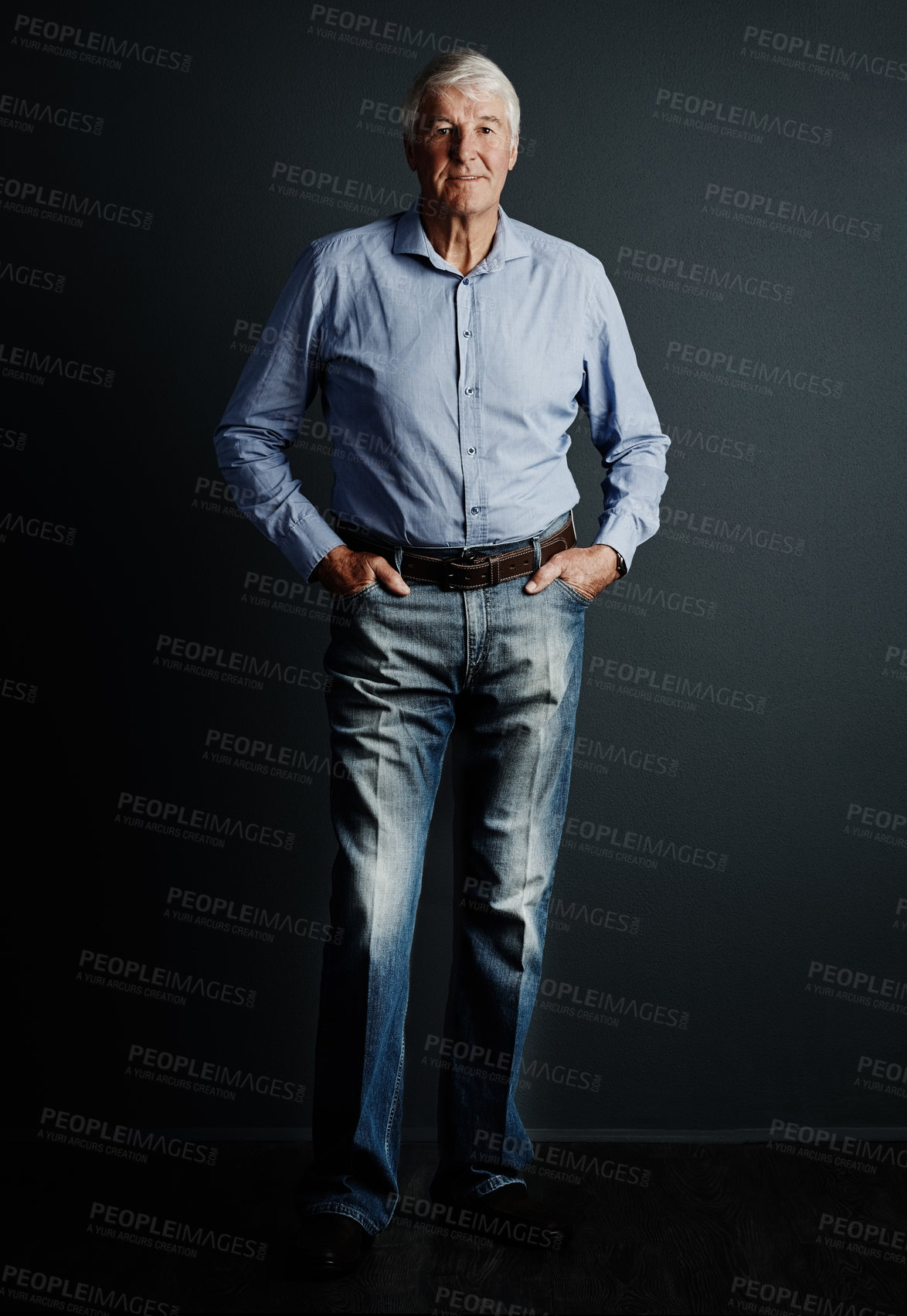 Buy stock photo Studio portrait of a handsome mature man posing against a dark background