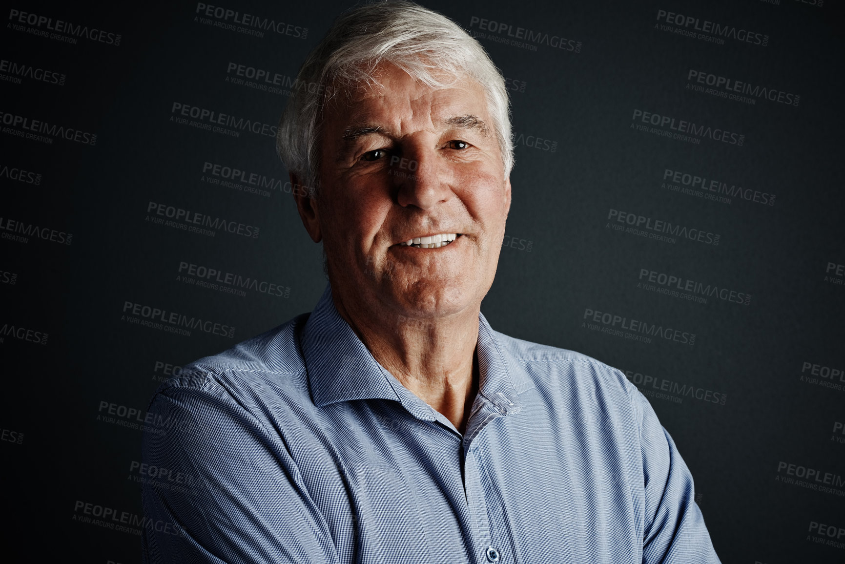 Buy stock photo Studio portrait of a handsome mature man posing against a dark background