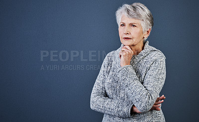 Buy stock photo Studio shot of a cheerful elderly woman standing and thinking while looking into the distance