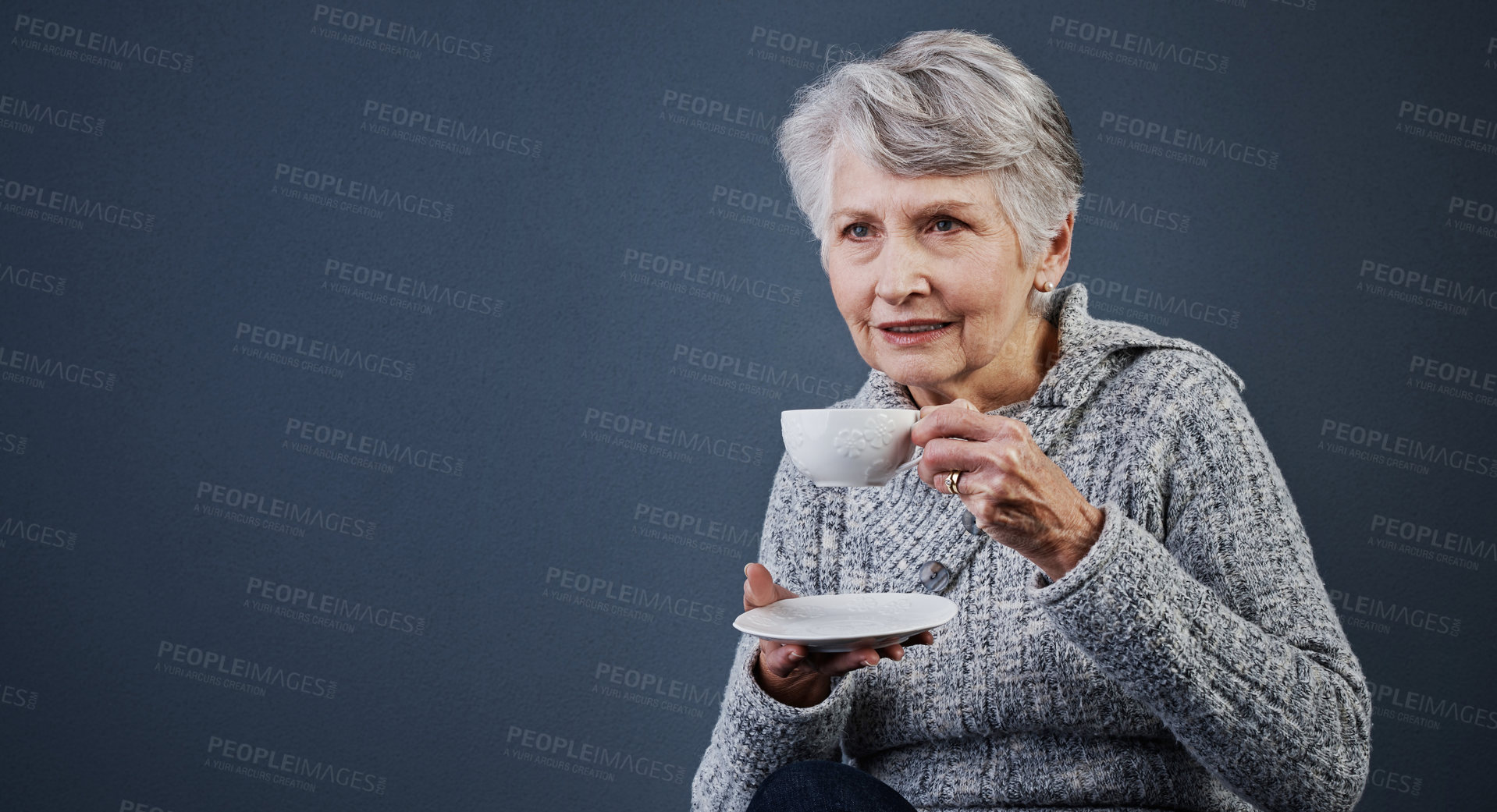 Buy stock photo Relax, tea and thinking with old woman in studio for break, me time or retirement ideas. Cup, pause and space with thoughtful senior person drinking beverage on gray background for reset or wellness