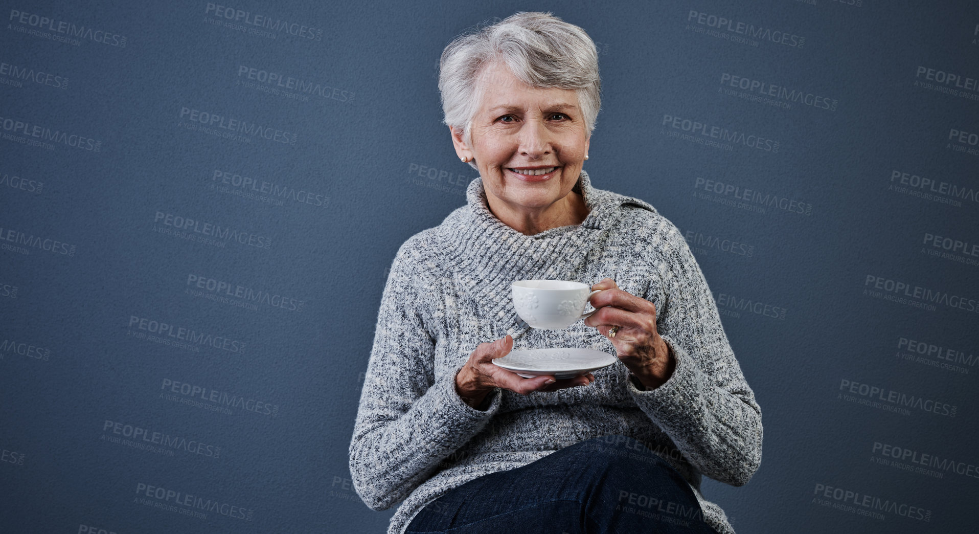 Buy stock photo Portrait, smile and tea with senior woman in studio to relax for break, me time or retirement. Cup, pause and space with happy old person drinking beverage on gray background for reset or wellness