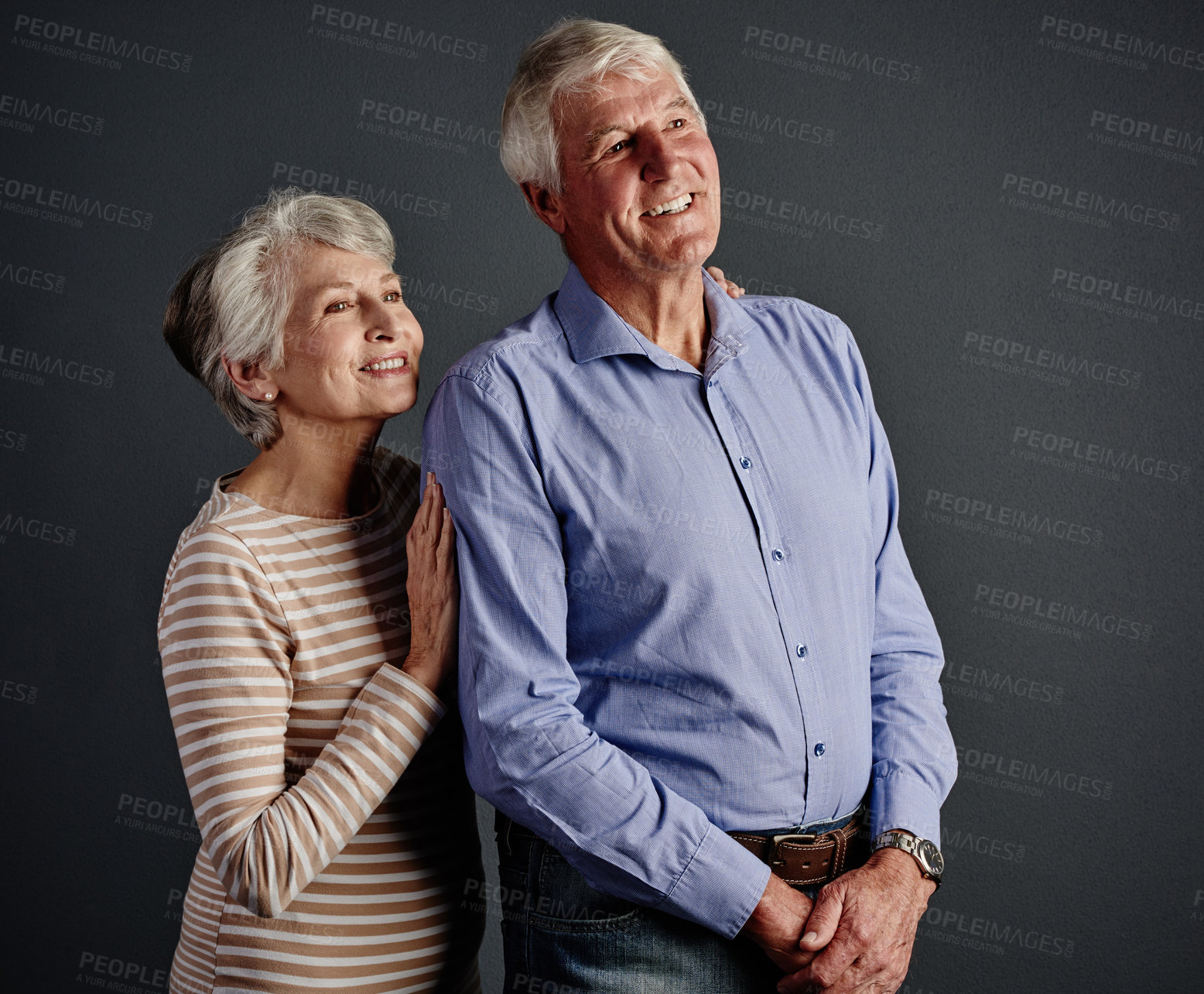 Buy stock photo Studio shot of an affectionate senior couple posing against a grey background