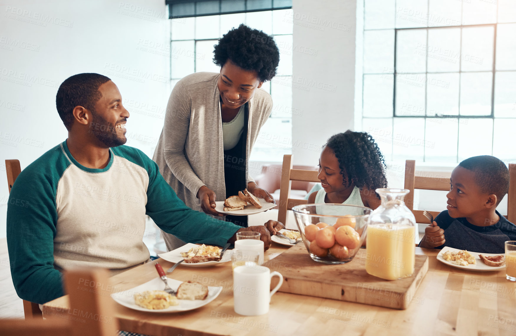 Buy stock photo Black family, parents and kids with food for breakfast in home with serving, bonding or happy in dining room. Love, mother or father with children in morning with eggs and bread for nutrition or meal