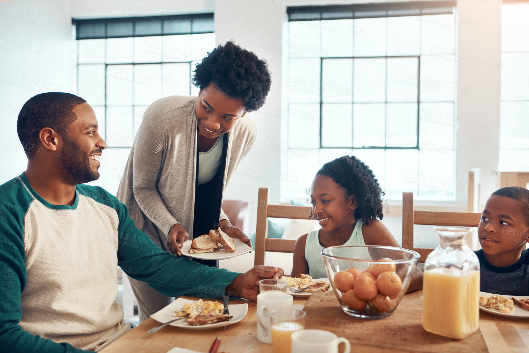 Buy stock photo Black family, parents and kids with food for breakfast in home with serving, bonding and happy for healthy meal. Love, mom and dad with children in morning with talking, eggs and bread for nutrition