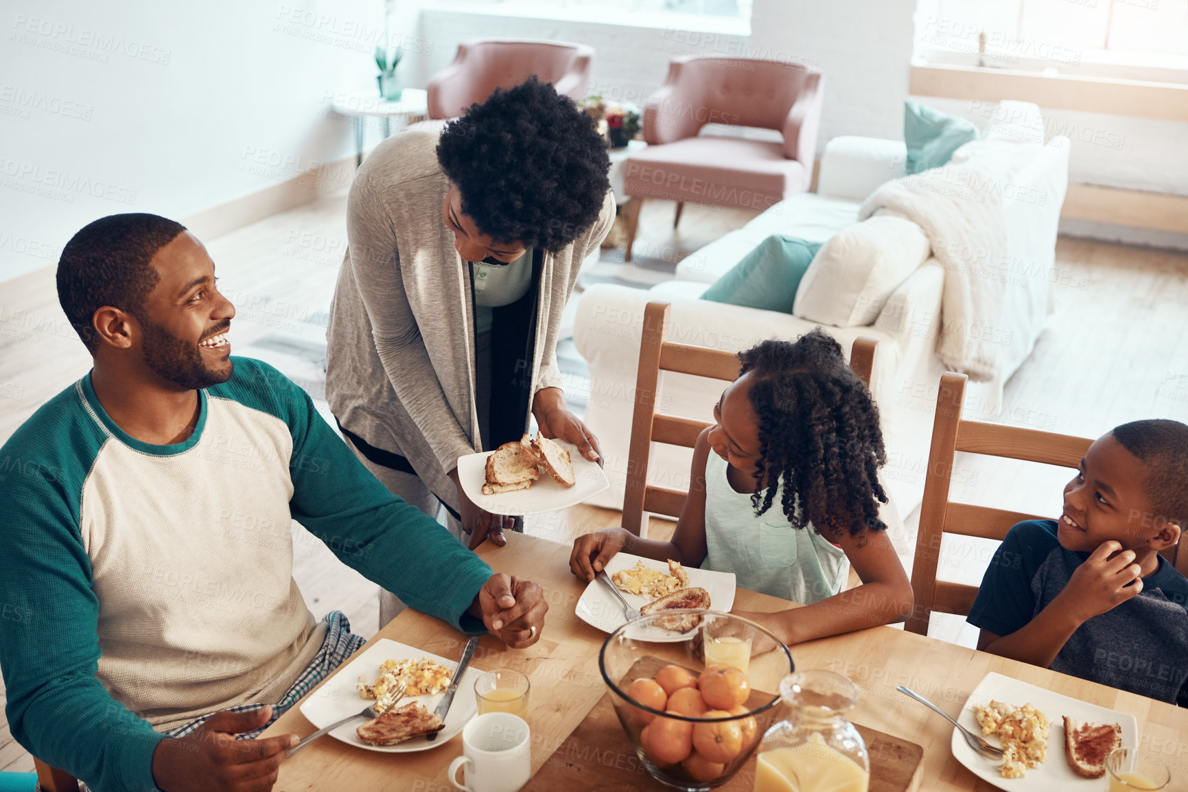 Buy stock photo Happy family, parents and children with food for breakfast in home with serving, bonding and top view in dining room. Black people, mom and dad with kids in morning with eggs and bread for nutrition