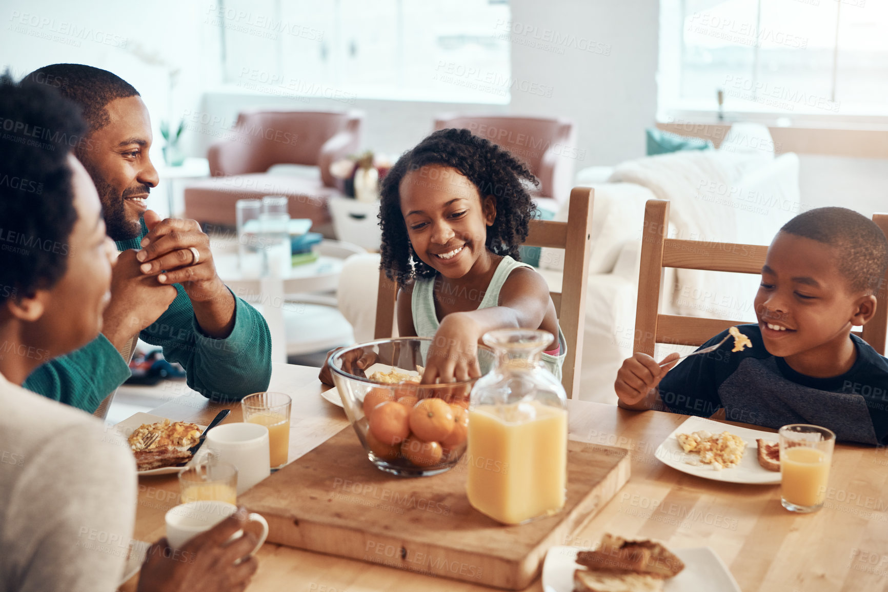 Buy stock photo Black people, parents and children with food for breakfast in home with eating, bonding and happy in dining room. Love, mom and dad with kids in morning with eggs and bread for nutrition and hungry