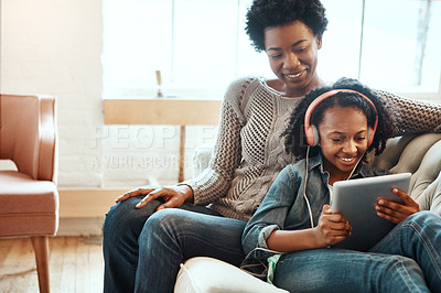 Buy stock photo Tablet, woman and child with headphones on sofa for digital media, streaming or entertainment on weekend. Happy, black family and girl with tech at home for online movie, subscription or connectivity