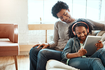 Buy stock photo Tablet, woman and child with headphones on couch for online film, streaming and media at home. Happy, black family and girl with tech in living room for digital movie, subscription and entertainment