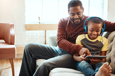 Buy stock photo Tablet, relax and father with boy on a sofa watching a funny, comic or meme video on social media. Happy, smile and African man streaming a movie with child on mobile device while relaxing together.
